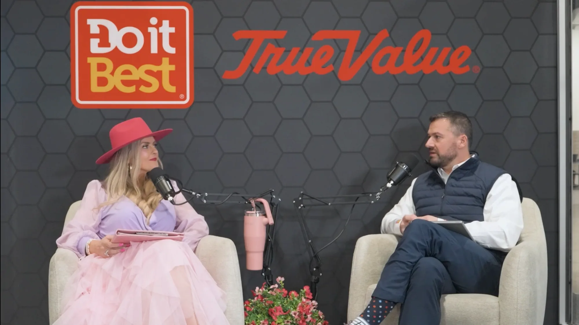 Stefanie Couch recording a live podcast episode at the Do it Best booth